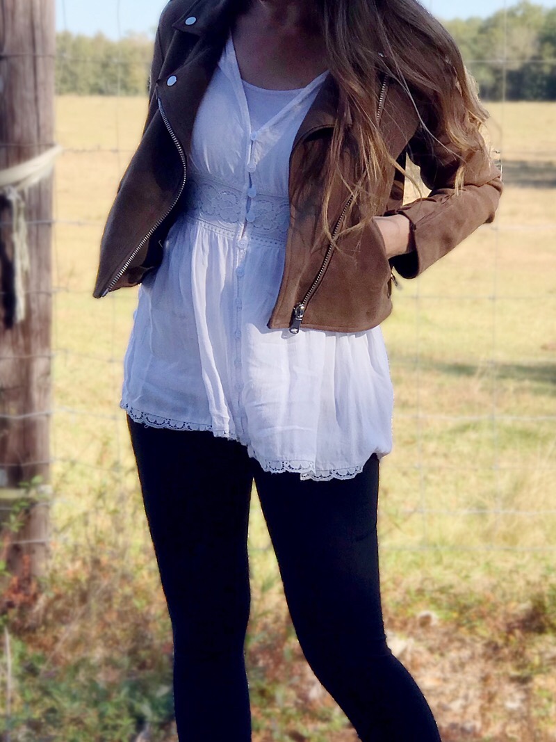 Model wearing long blouse with leggings in the countryside