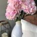 pink faux hydrangeas in white ceramic vase on porch for spring decor from hobby lobby