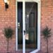 myrtle tree flanking front door for spring front porch decor