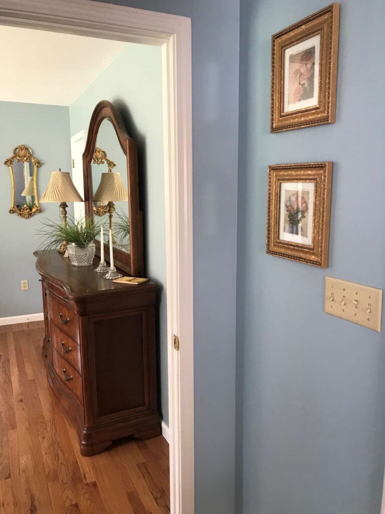 blue painted walls with gold framed artwork