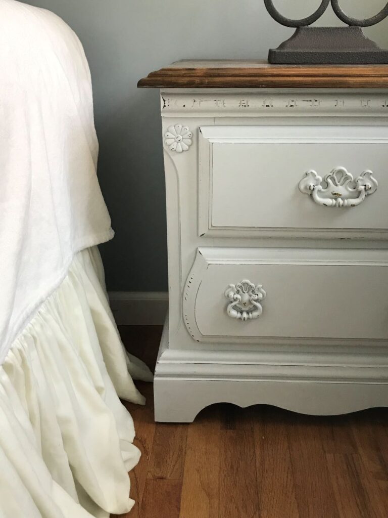 french country romantic master bedroom decor with ruffle bedskirt and wood furniture