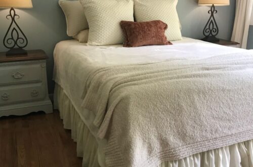 master bedroom bed with nightstands and lamps