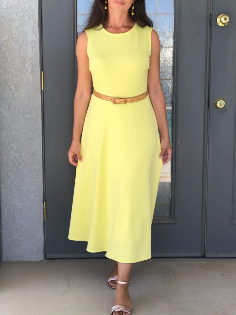woman wearing a yellow midi length sundress