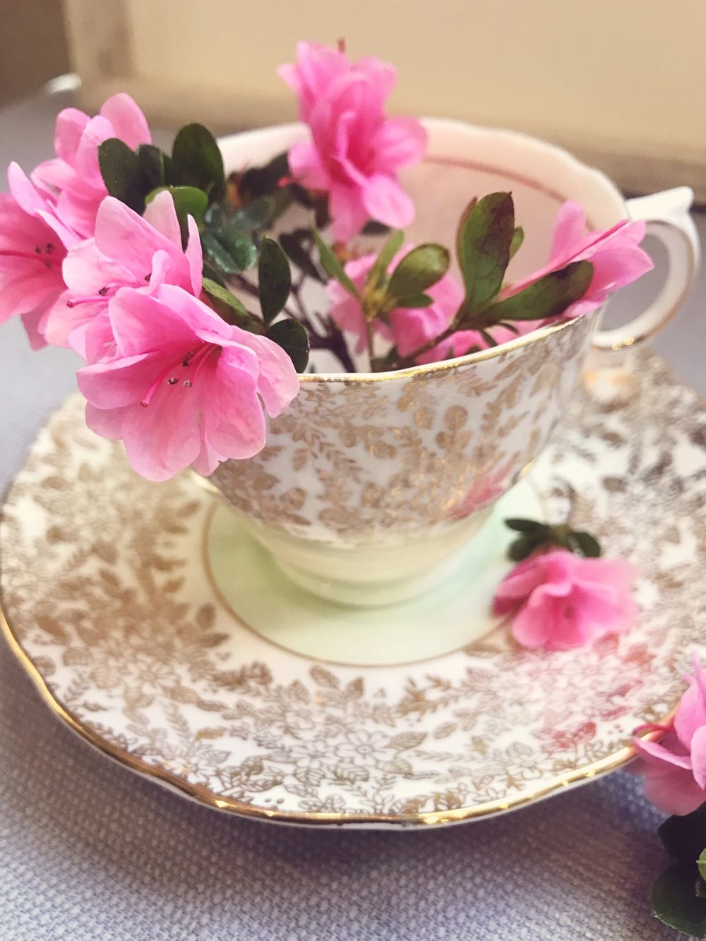 teacup with pink flowers in it