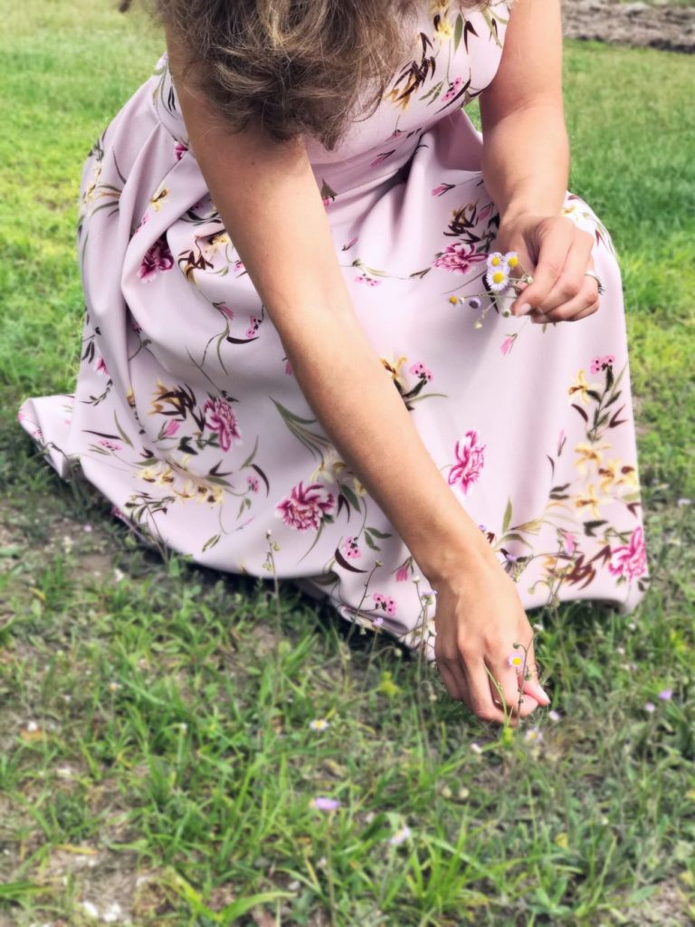 picking flowers in a lavender dress